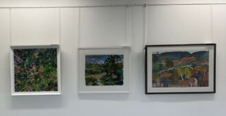 3 paintings from the Biophilia exhibition, the first is colourful riot of pink and yellow flower with green leaves, the second has trees in the foreground looking away to green hills and blue sky with clouds. The final image is an autumn view of trees with blue/green hills in the background.