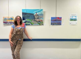 Artist Alison Jacobs stood next to her recently installed exhibition