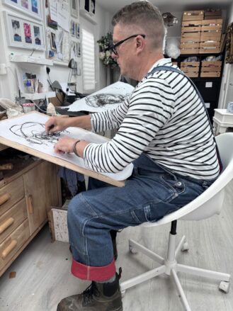 Artist, Angus Selene working in his studio