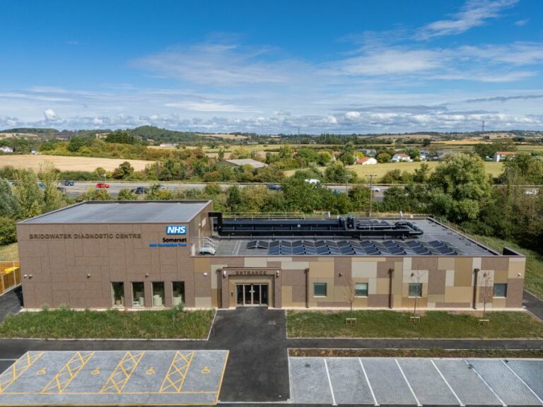 Exterior view of the NHS Somerset Bridgwater Diagnostic Centre, showing the main entrance and modern healthcare building under a blue sky.