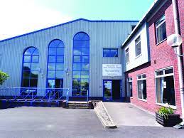 A modern church building with large arch windows.