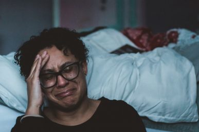 Female Adult Crying in Bed