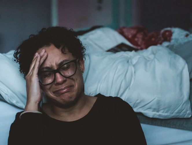 Female Adult Crying in Bed