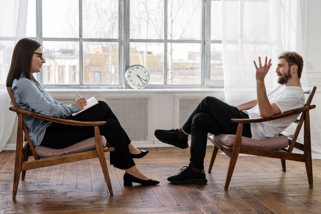 Male and a female having a counselling session.