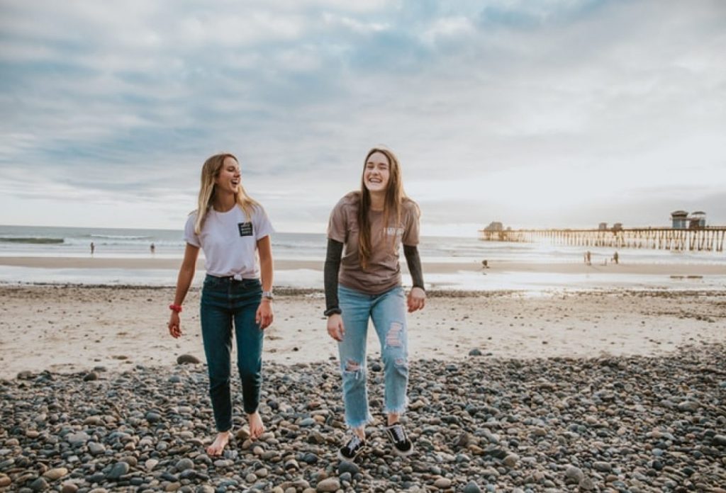 Two smiling women at the beach