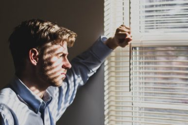 Male Adult Looking Out The Window