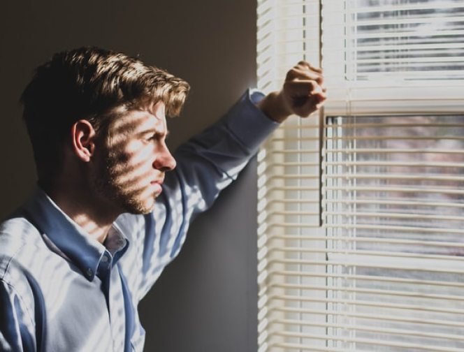 Male Adult Looking Out The Window