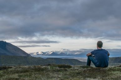 Male Adult Sitting on a Hill