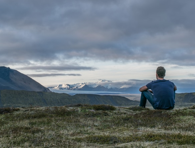 Male Adult Sitting on a Hill