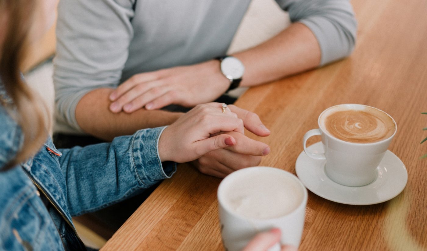 Two Adults Talking Over Tea