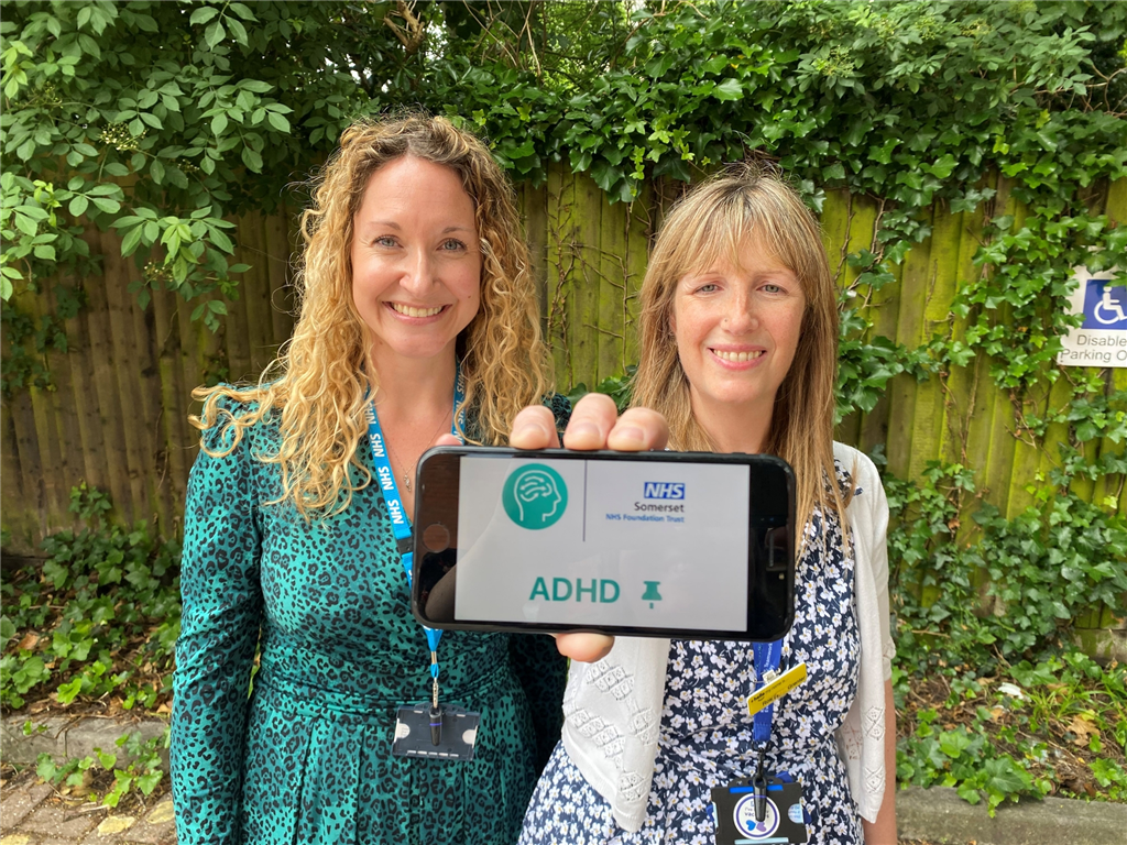 twp female staff members holding a mobile phone showing the connect app