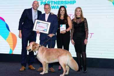 A photo of four colleagues involved in the Sector-based Workplace Academy Programme (SWAP) in Somerset, with Nathan - who is a labrador dog.