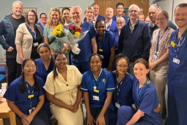 Dr Stirling Pugh holding a bunch of flowers, standing with colleagues in the endoscopy department at Musgrove Park Hospital.