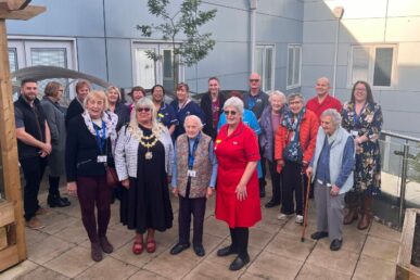 Colleagues and volunteers celebrate Bridgwater Hospital's 10th anniversary in the newly refurbished garden area.