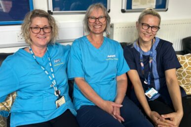 A photo of three colleagues from the cleaning team at Musgrove Park Hospital celebrating the 35th anniversary of Sue Lee working for the NHS.