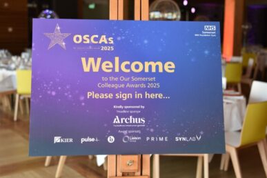 Purple sign saying 'welcome to the our somerset colleague awards 2025'