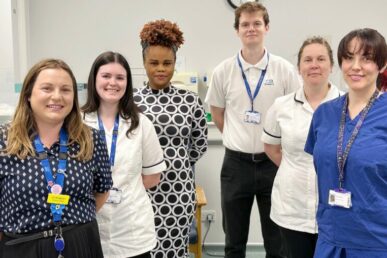 Six colleagues from Somerset NHS Foundation Trust's podiatry service standing in a treatment room.