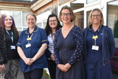 A photo of five clinicians involved in bariatric surgery stood outside a hospital building.