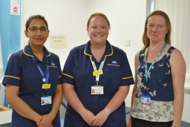 A photo of three colleagues involved in the psychosis in Parkinson's study, who are stood in a clinic room.