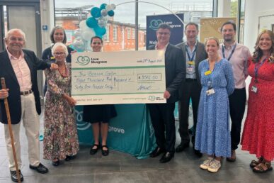 Fundraiser Mary Nicholson handing over a giant cheque to colleagues at Musgrove Park Hospital.
