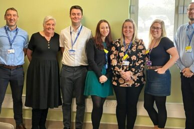 Seven colleagues from our tobacco reduction team stood up in a room.