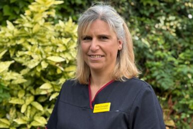 A photo of radiographer Stella Campbell with greenery in the background.