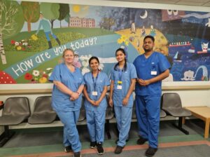 Four colleagues from Somerset's audiology service stood in a hospital corridor.