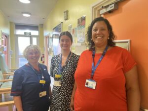 Three colleagues from Somerset's maternity unit stood in a corridor at Wellington Hospital.