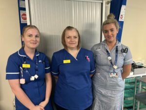 Three colleagues from Somerset's community services stood in a clinic room at Wellington Hospital.