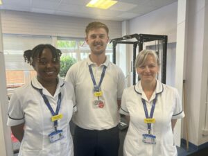 Three colleagues from Somerset's physiotherapy team stood in a physio at Wellington Hospital.