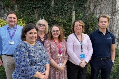 Colleagues from the sleep apnoea team at Yeovil Hospital stood outside the department next to greenery.