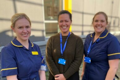 A photo of three tuberculosis specialist nurses in their uniform, stood outside a building at Musgrove Park Hospital.