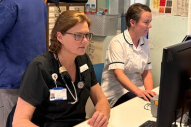 Two colleagues sat at a control desk at Musgrove Park Hospital's emergency department.