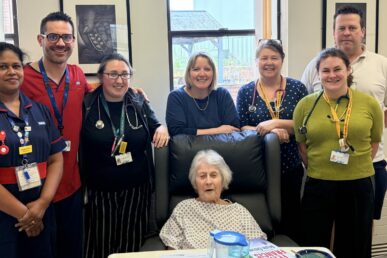 A photo of colleagues in the frailty same day emergency care team at Musgrove Park Hospital stood with a patient.