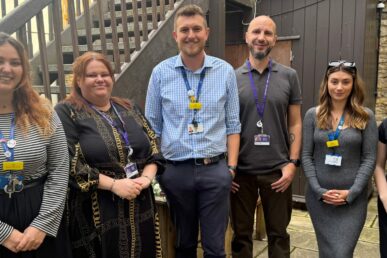 Colleagues from Somerset NHS Foundation Trust's home treatment team are stood with colleagues from Rethink Mental Illness in The Foyer building in Yeovil.
