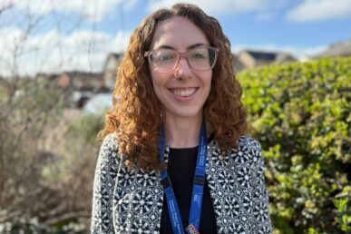 A photo of clinical psychologist, Doctor Megan Rowley, stood in front of greenery.
