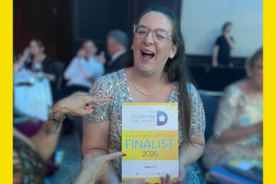 A photo of Emily Hitchens, dementia and delirium educator at our trust, stood holding a certificate for her award.