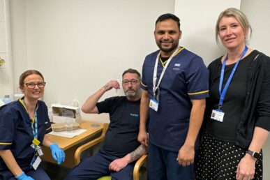 Three colleagues from the Somerset NHS Foundation Trust endoscopy team with a patient who is holding a capsule sponge kit.