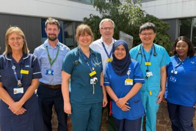 A group of colleagues from the acute medical unit at Musgrove Park Hospital stood in a courtyard at the hospital.