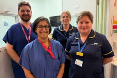 A group of colleagues involved in research and vascular care stood in an operating theatre anaesthetic room.