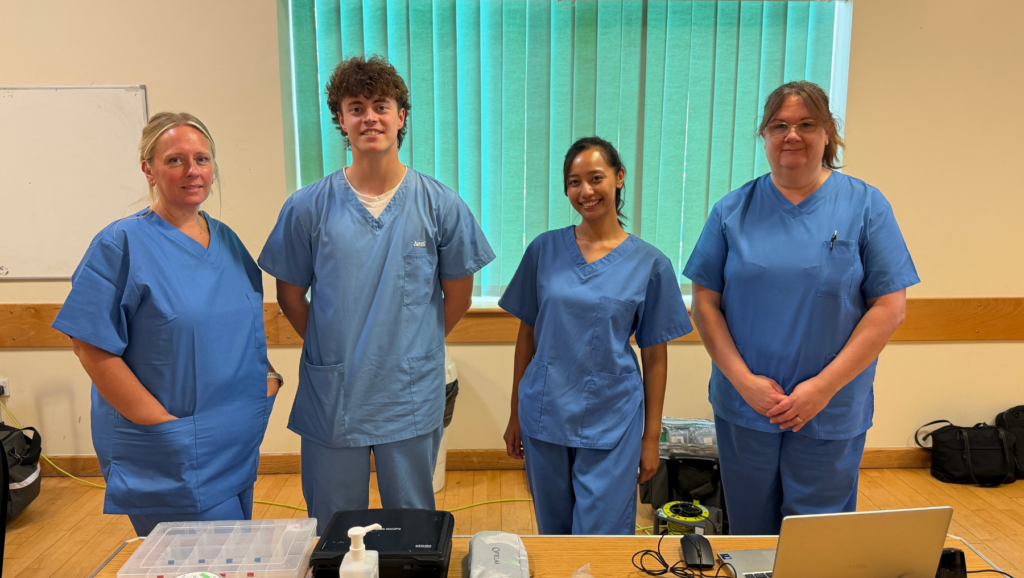 A photo of four colleagues from our audiology service at Musgrove Park Hospital in light blue uniforms.