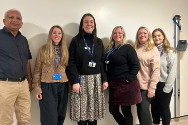 A photo of six colleagues from the Somerset mental health rehabilitation team stood in a row in a room.