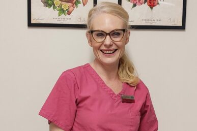 A photo of Doctor Kathryn Patrick in pink medical scrubs.